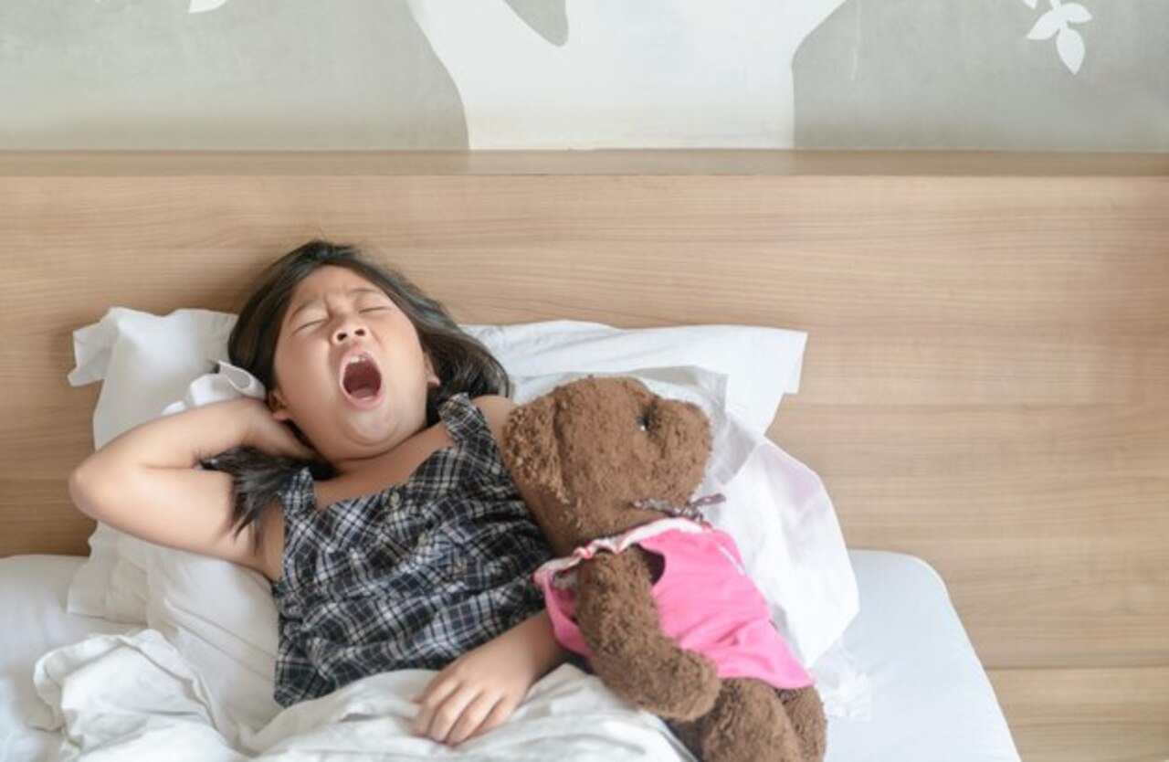 Child in bed with teddy bear – Signs of Sleep Apnea in Kids