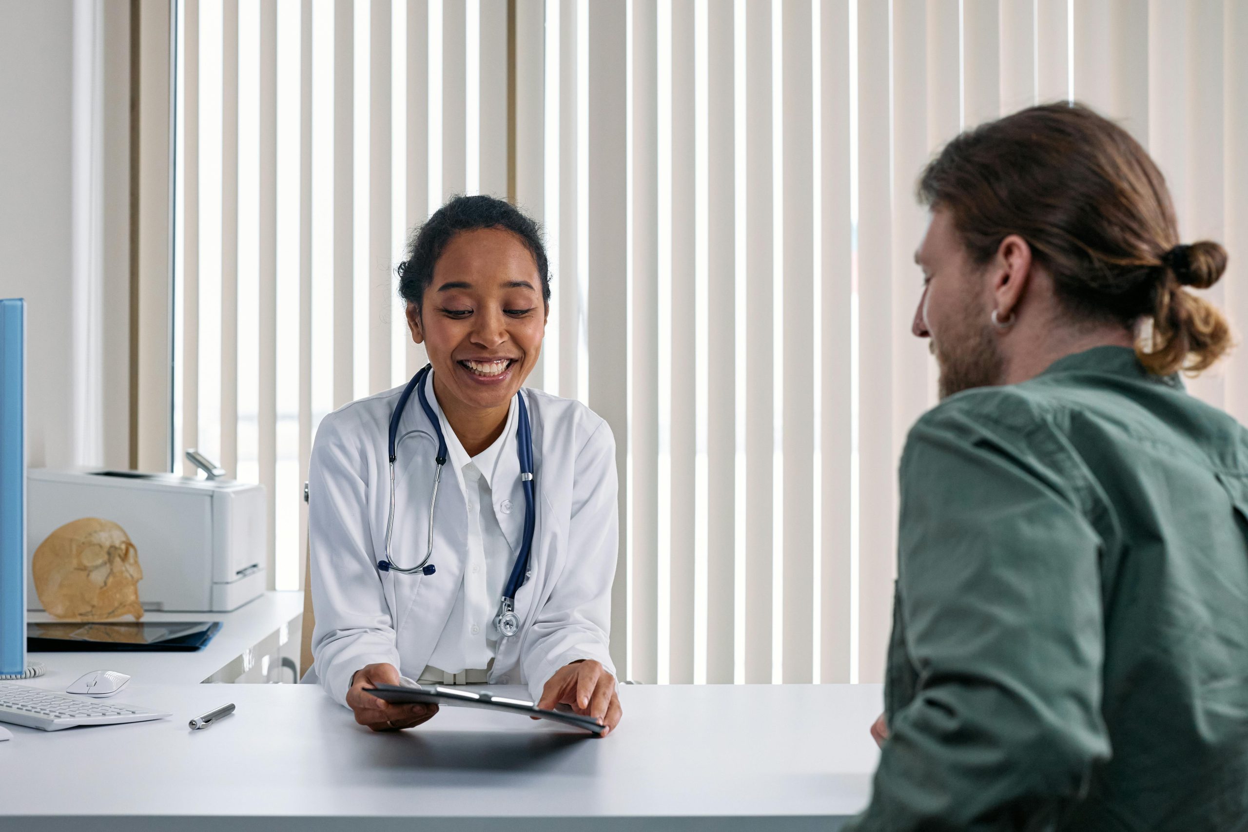 Doctor smiling while discussing with a patient.