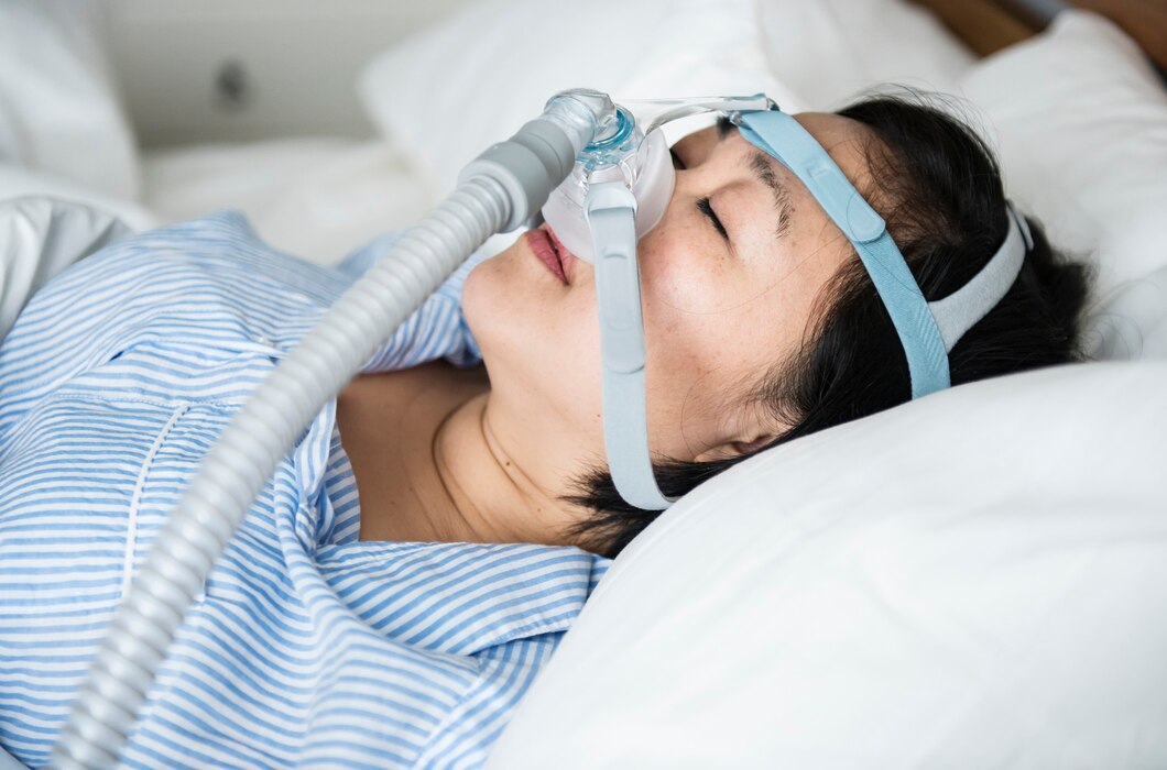 Woman using a CPAP mask for sleep apnea treatment at night.