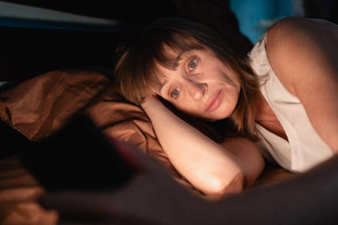 Person struggling with a common sleep disorder at night.