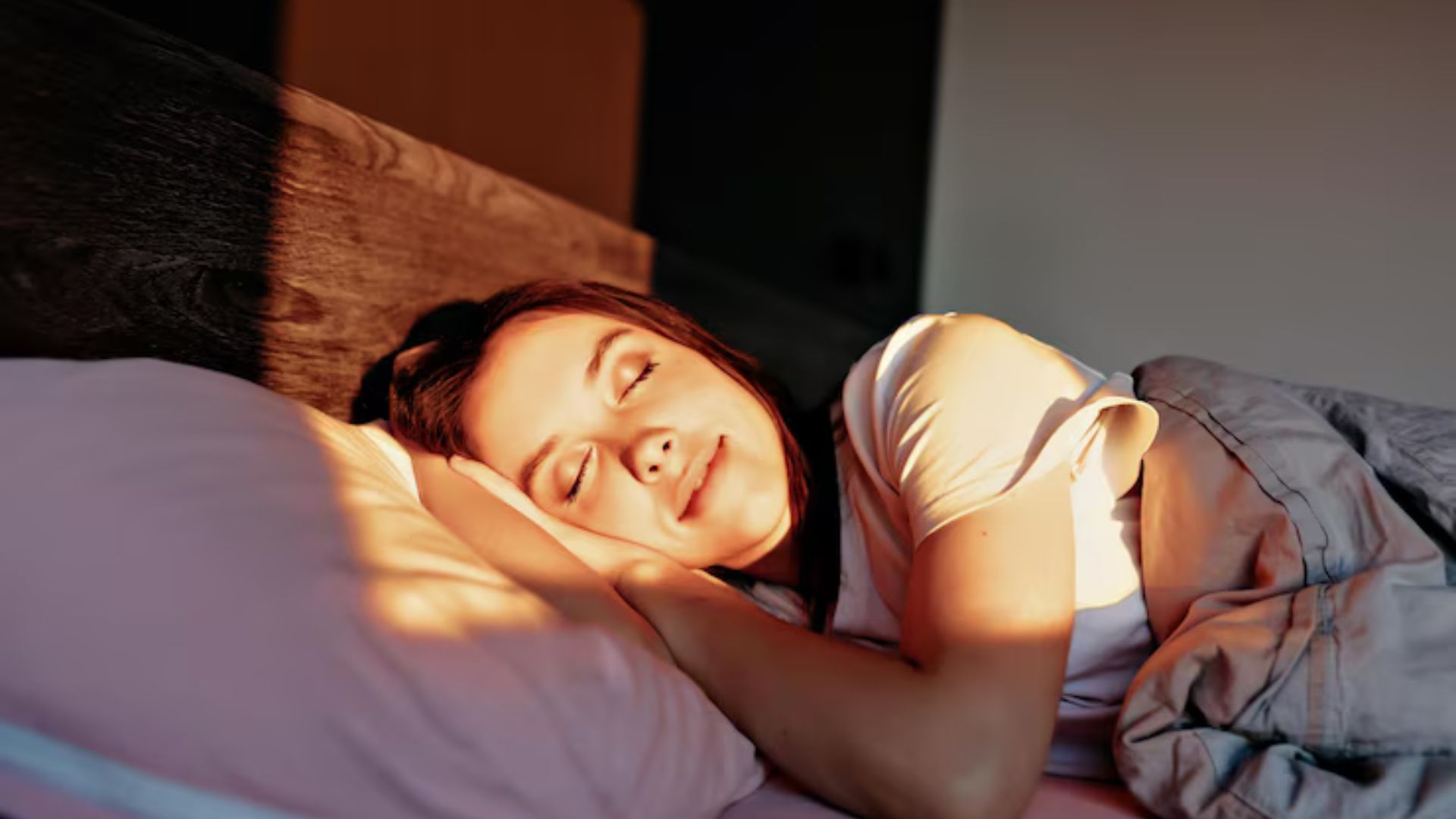 Woman sleeping peacefully with sunlight, boosting immunity.