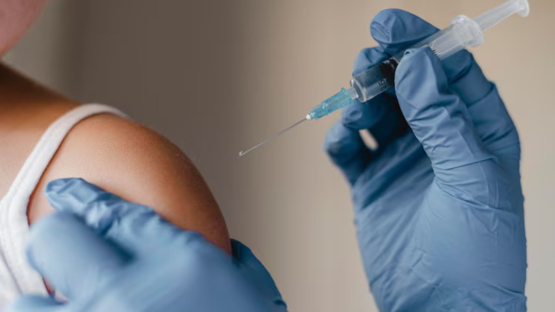 Nurse giving vaccine injection to patient, boosting immunity.
