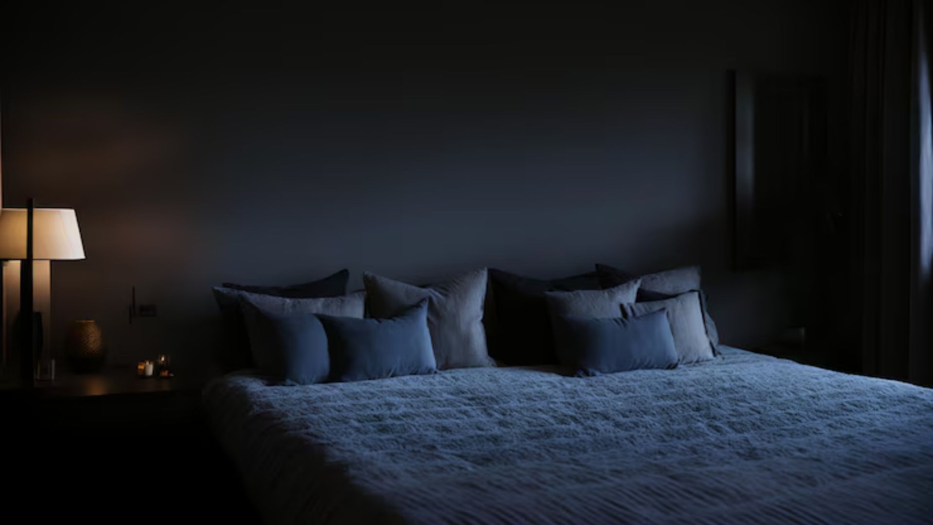 Dark, calm bedroom with soft lighting, ideal for sleep.