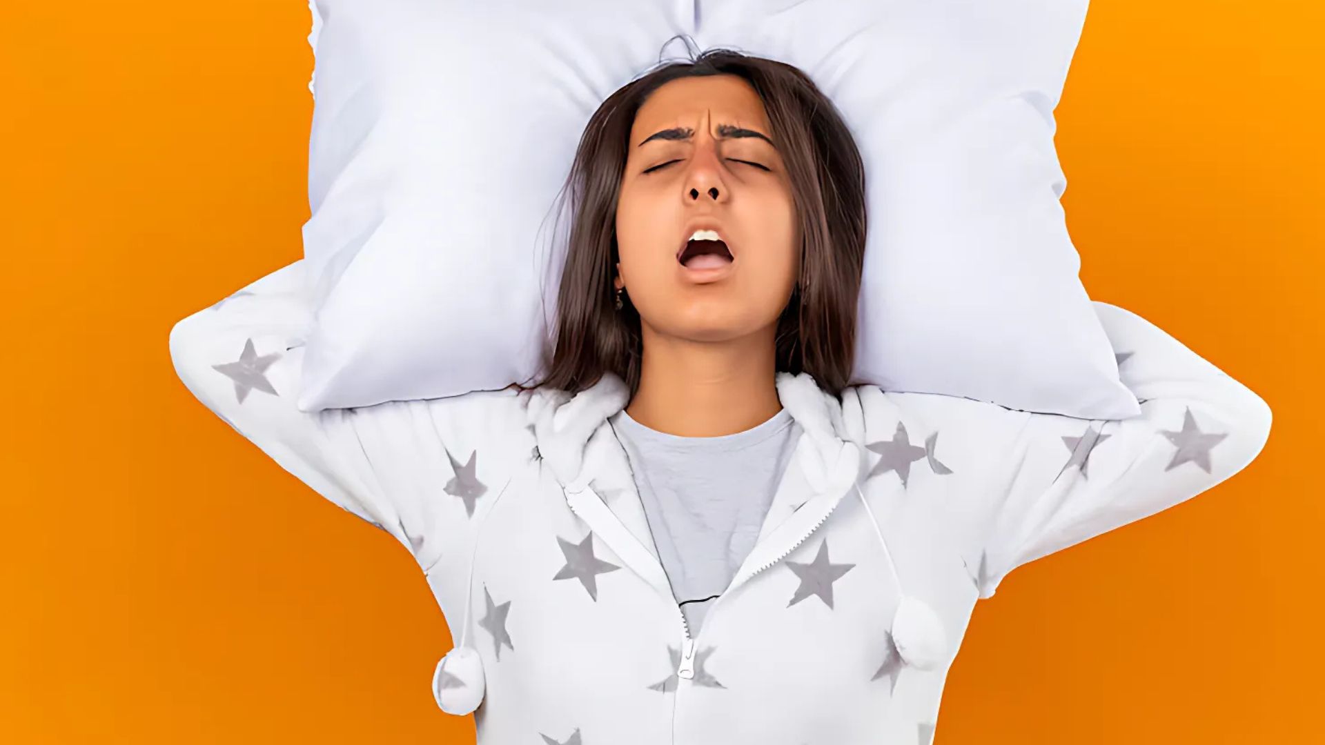 Woman covering her ears due to loud snoring in females.