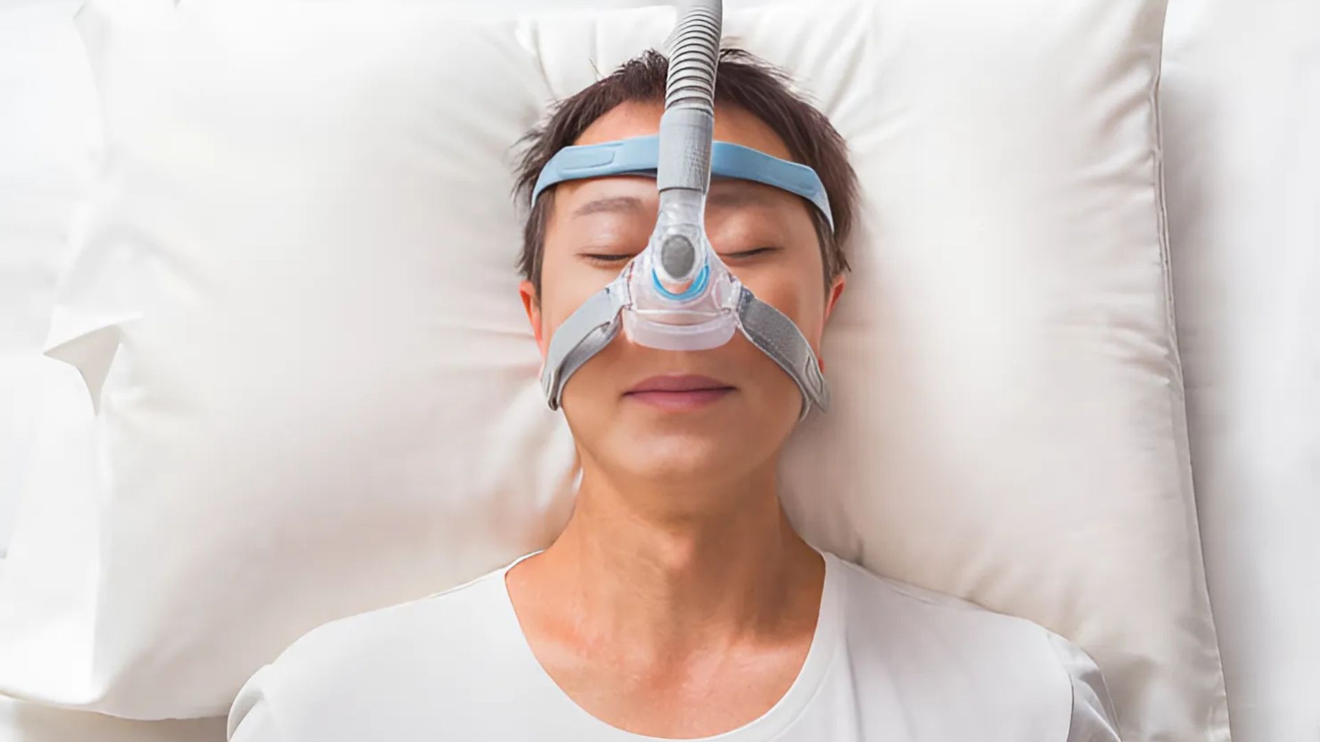 Woman using CPAP machine to stop snoring in females.