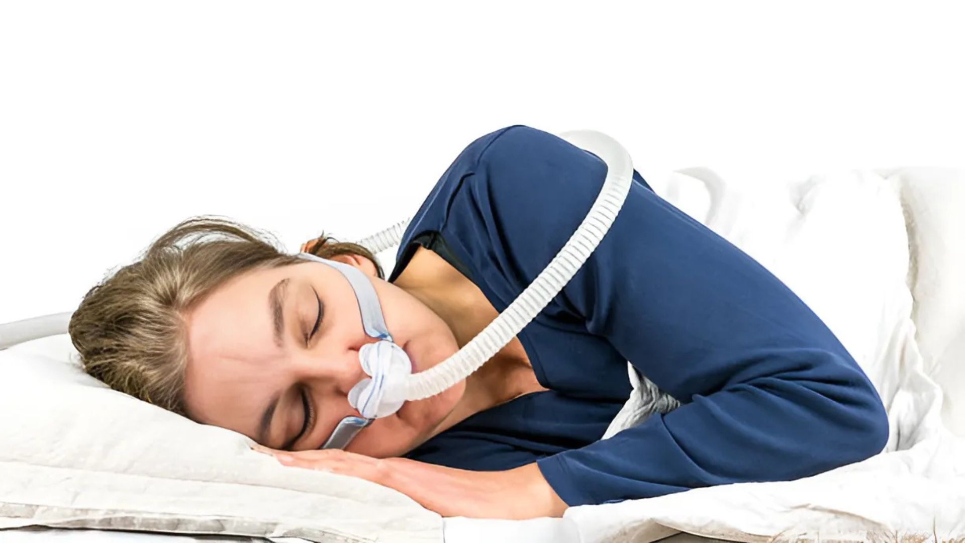 A woman sleeping with CPAP mask for sleep apnea therapy.