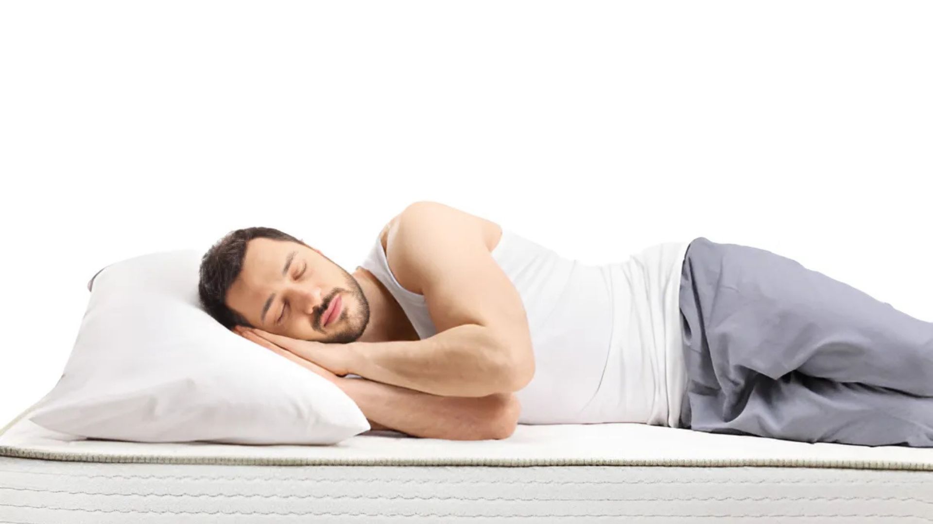 A man sleeping on his side, showcasing a good sleep position.