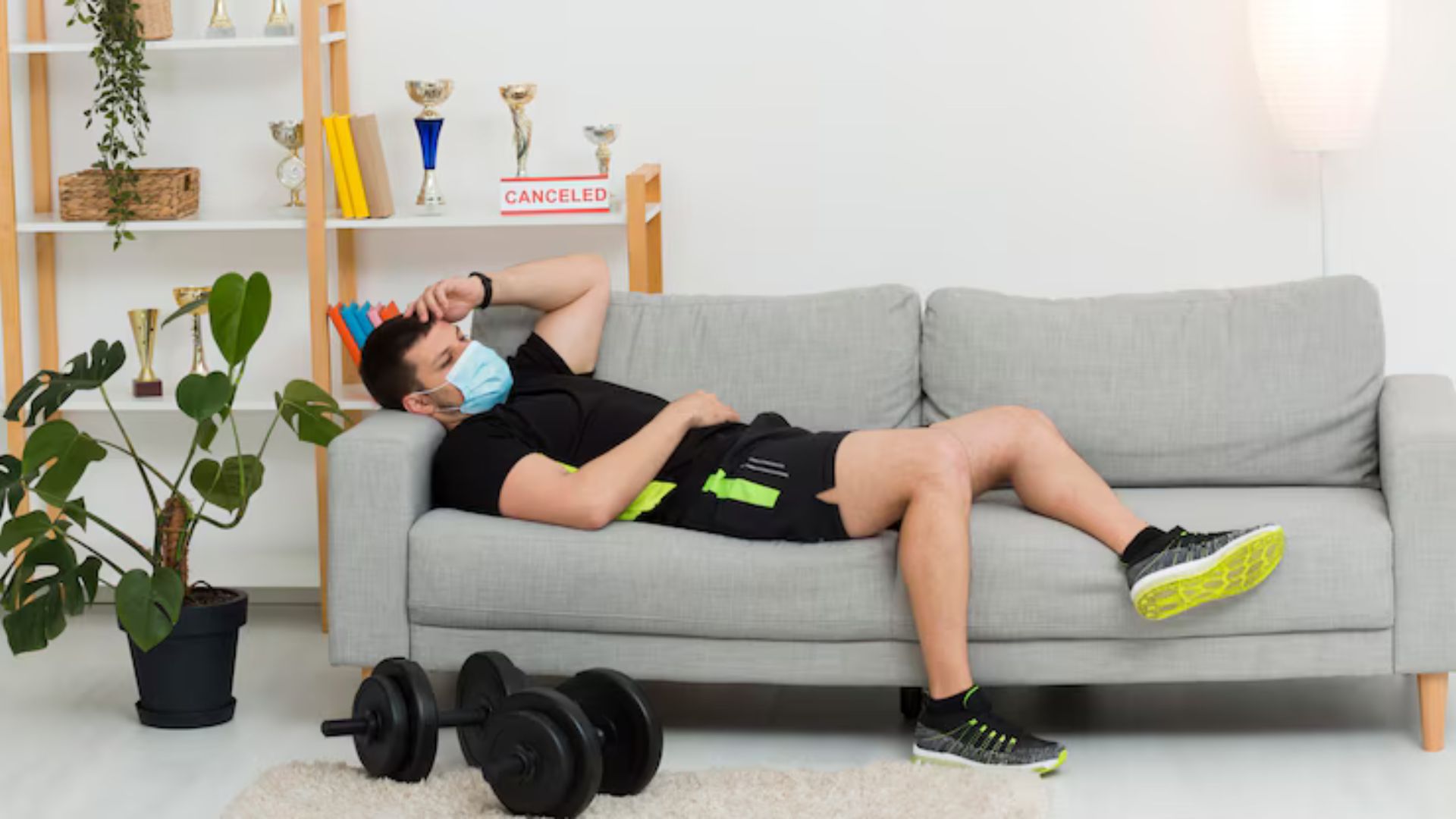 Athlete resting on a couch, demonstrating the importance of sleep for recovery.