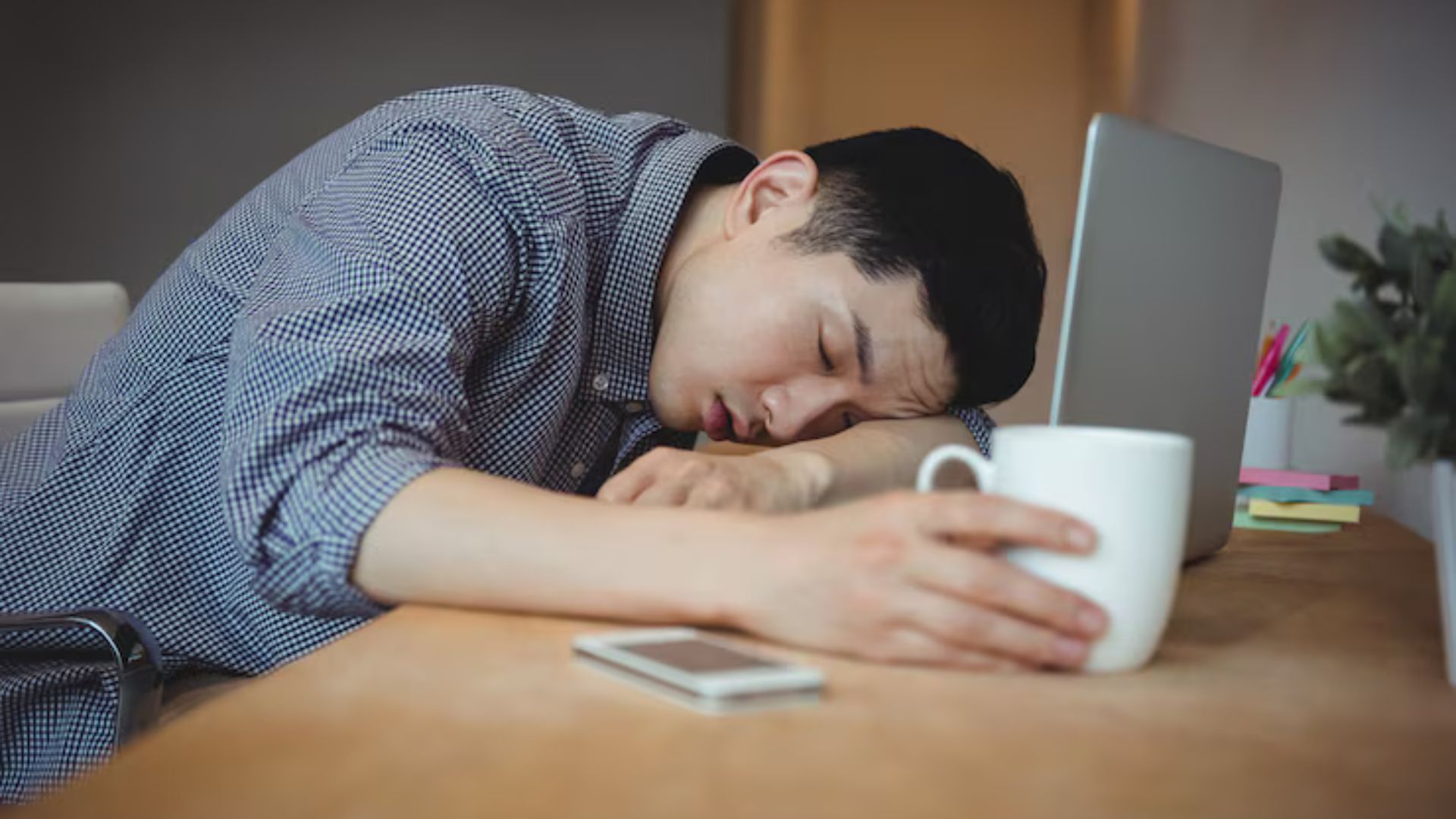 Man exhausted at work with head down, snoring could be a sign.
