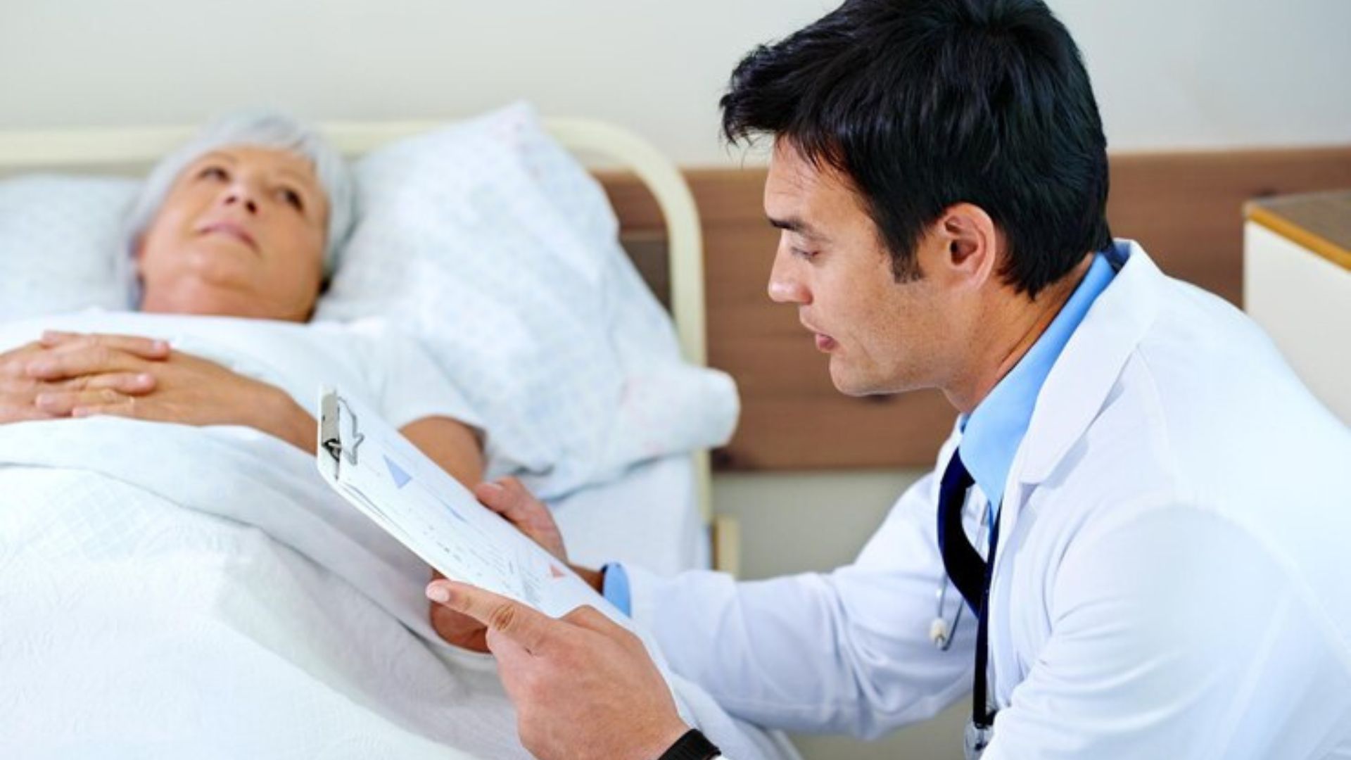 Doctor reviewing report with a patient about health condition