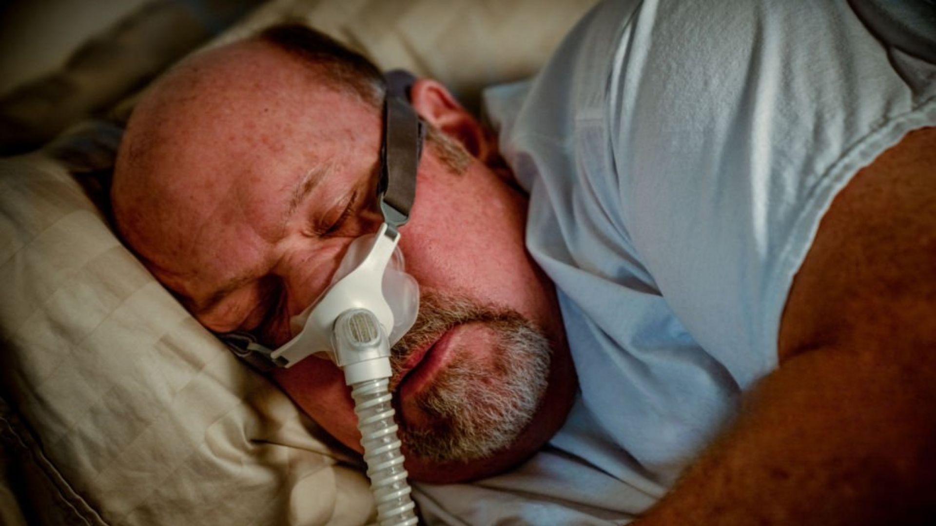Man sleeping with CPAP mask supporting sleep health care