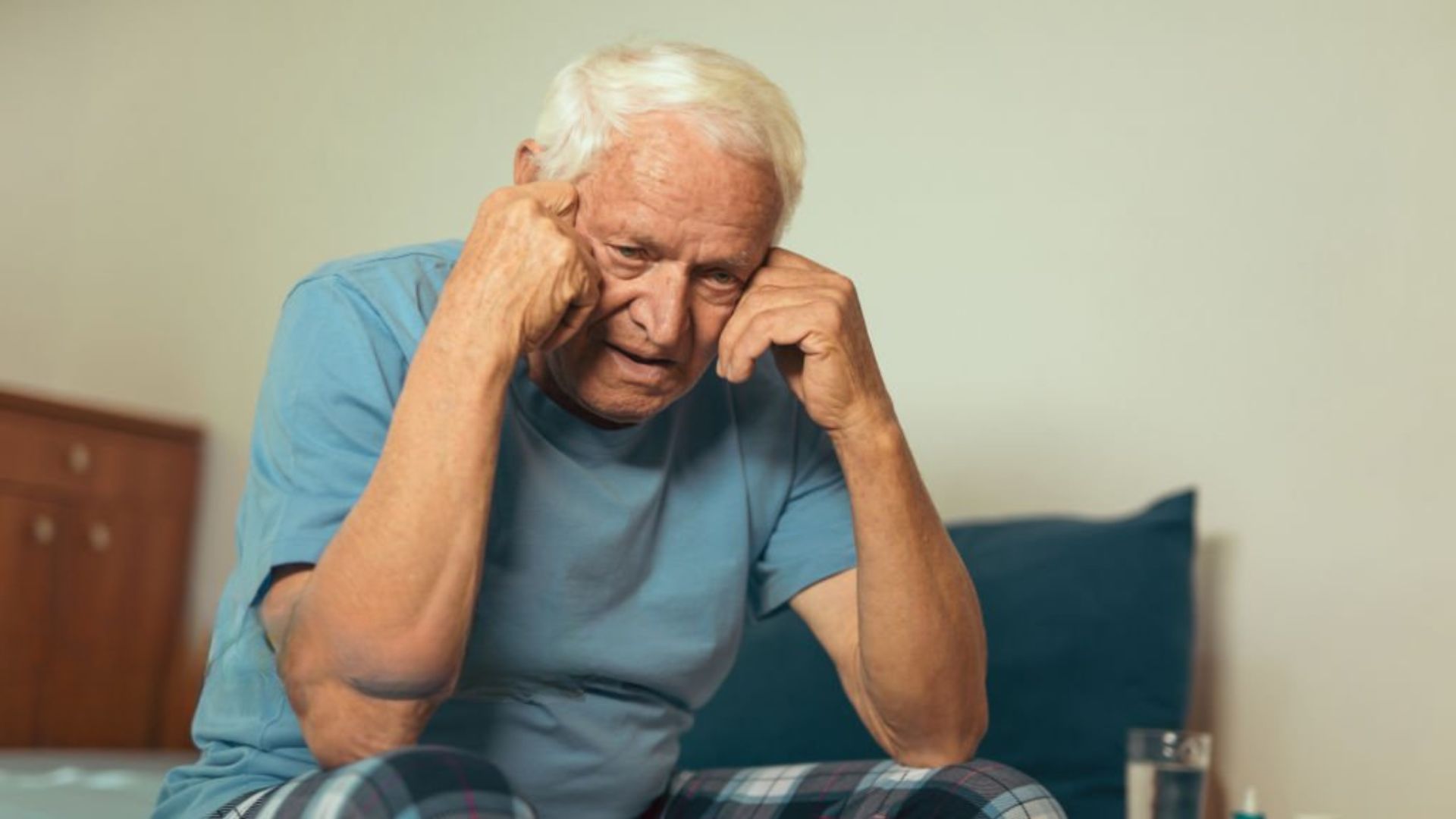 Older man feeling irritable due to lack of restful sleep