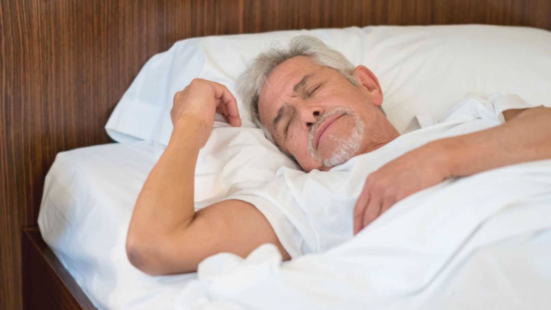 Older man enjoying a restful nap in bed