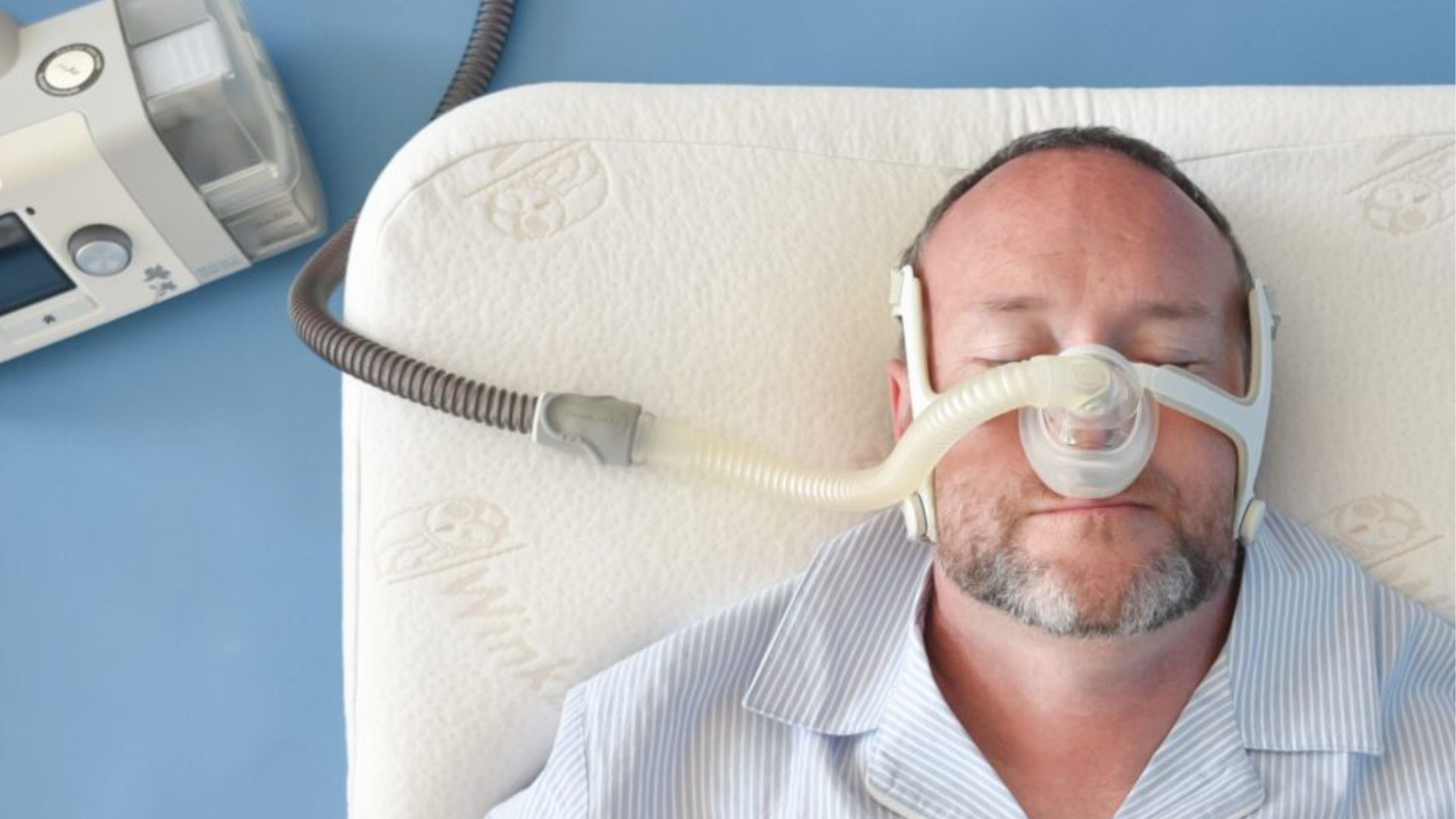 Man sleeping with CPAP mask showing sleep apnea therapy